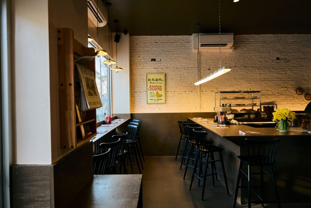 The L-shaped bar at the Park Slope Pies 'n' Thighs location in fron of a white-painted brick wall
