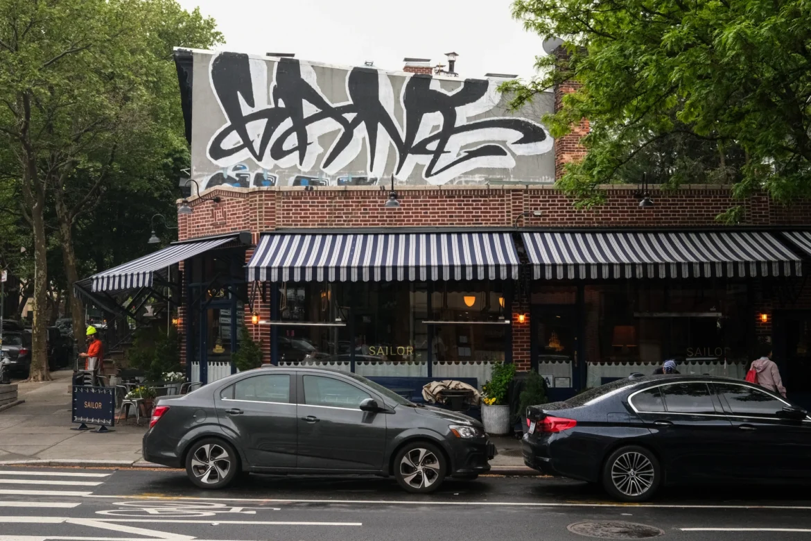 A one-story brick building houses the restaurant Sailor on a corner in Fort Greene